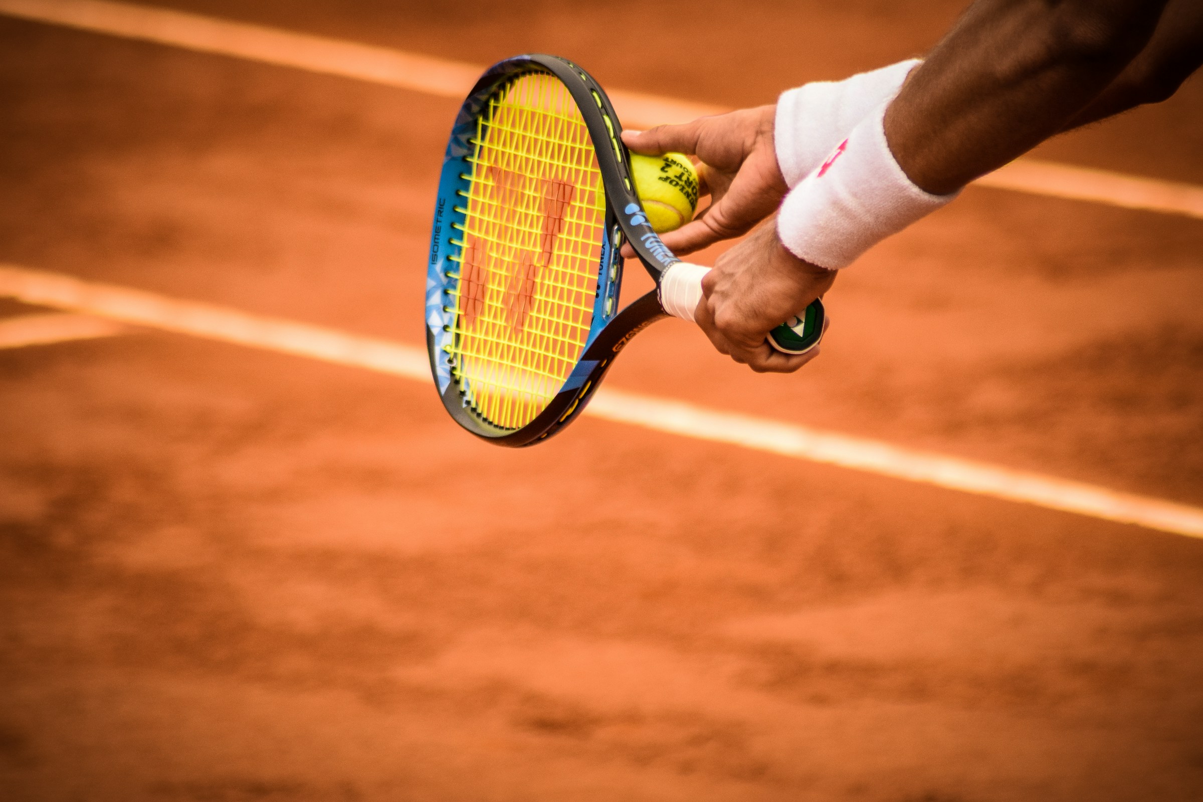 Tennis player getting ready to serve.